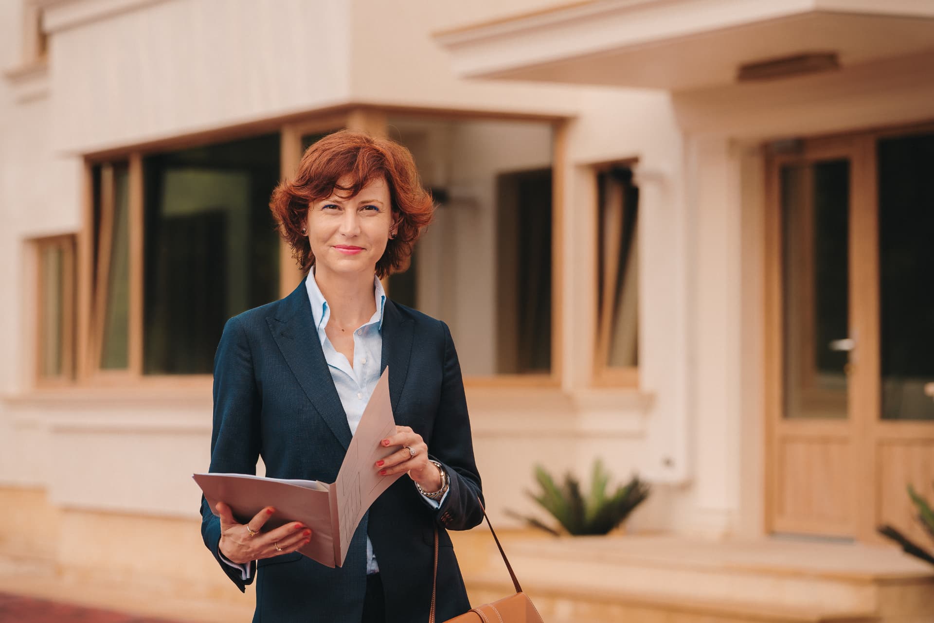 Andreea Lancea, consultant imobiliar, în fața unei proprietăți
