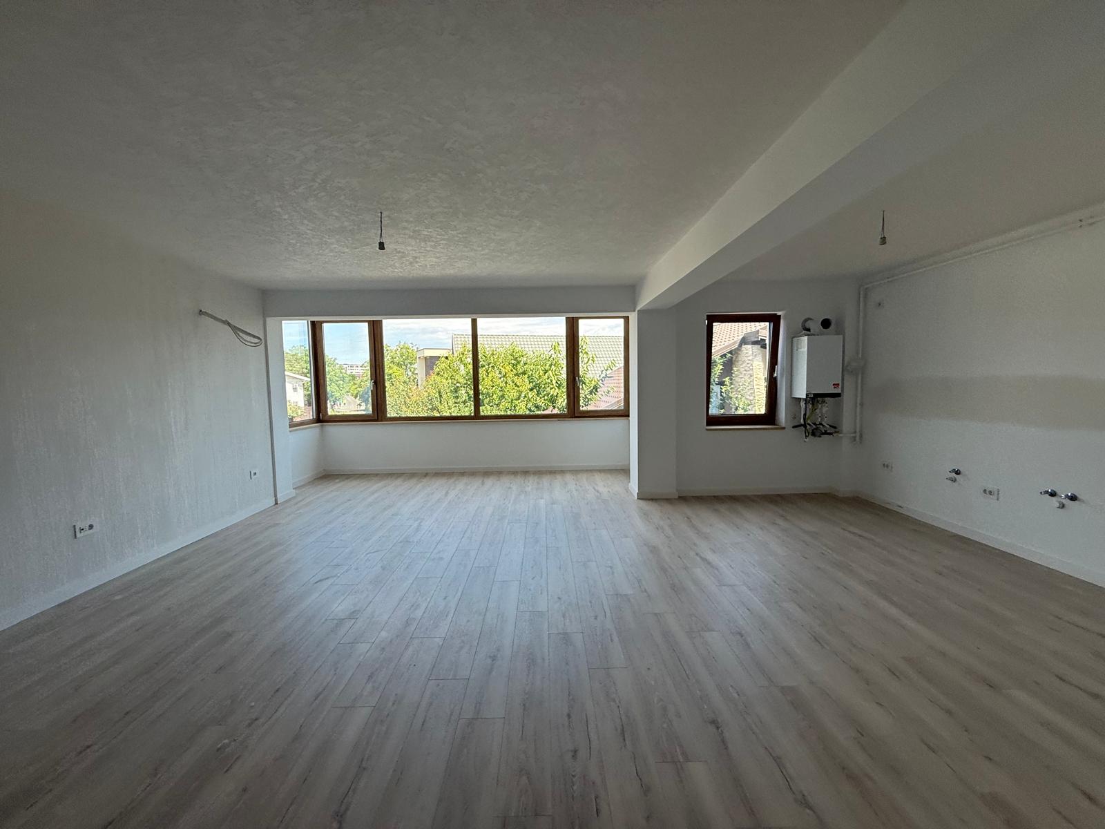 Living spațios cu zonă de bucătărie, centrală termică și ferestre panoramice
